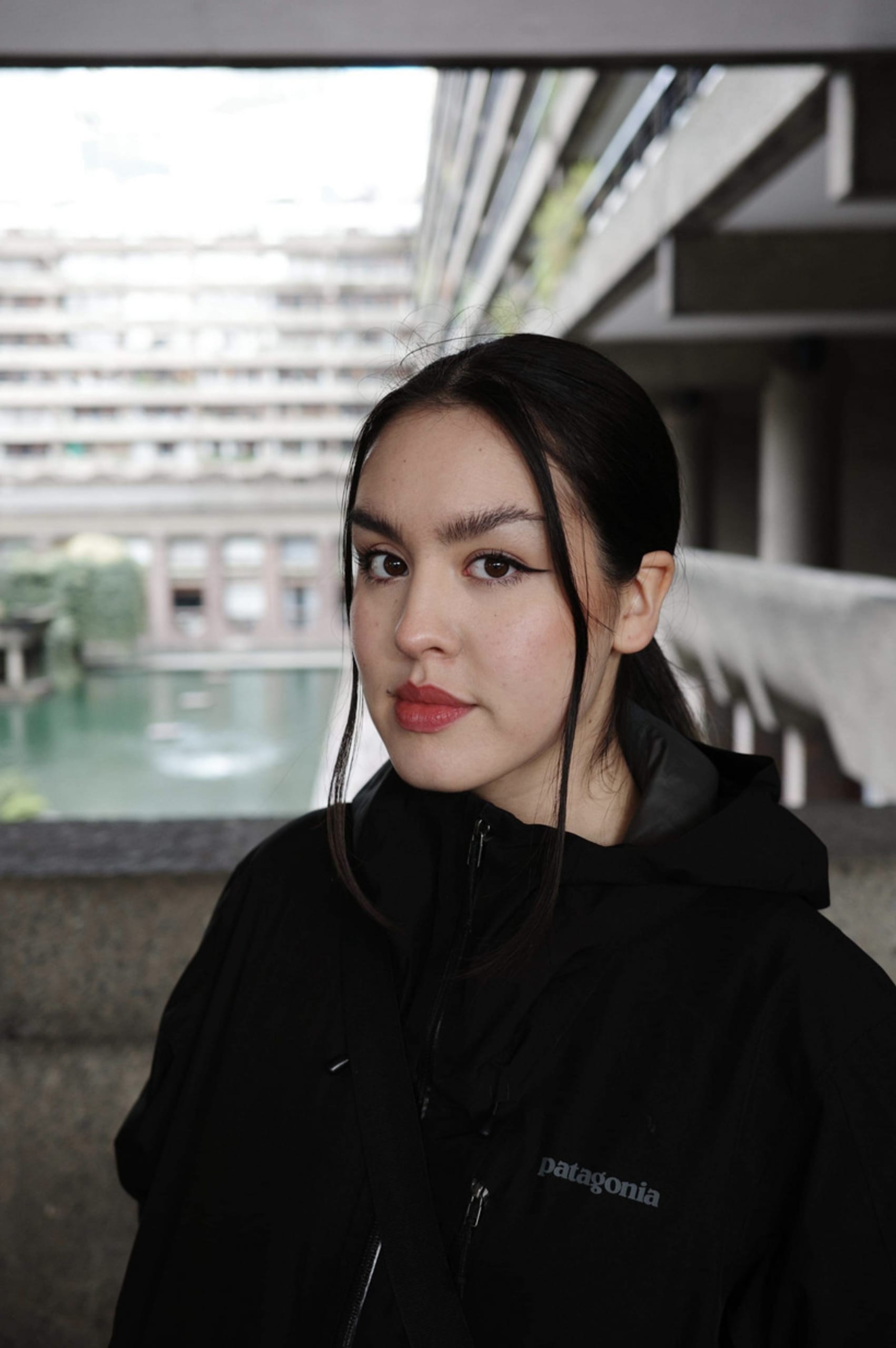 Portrait of a dark-haired girl wearing a black rain jacket