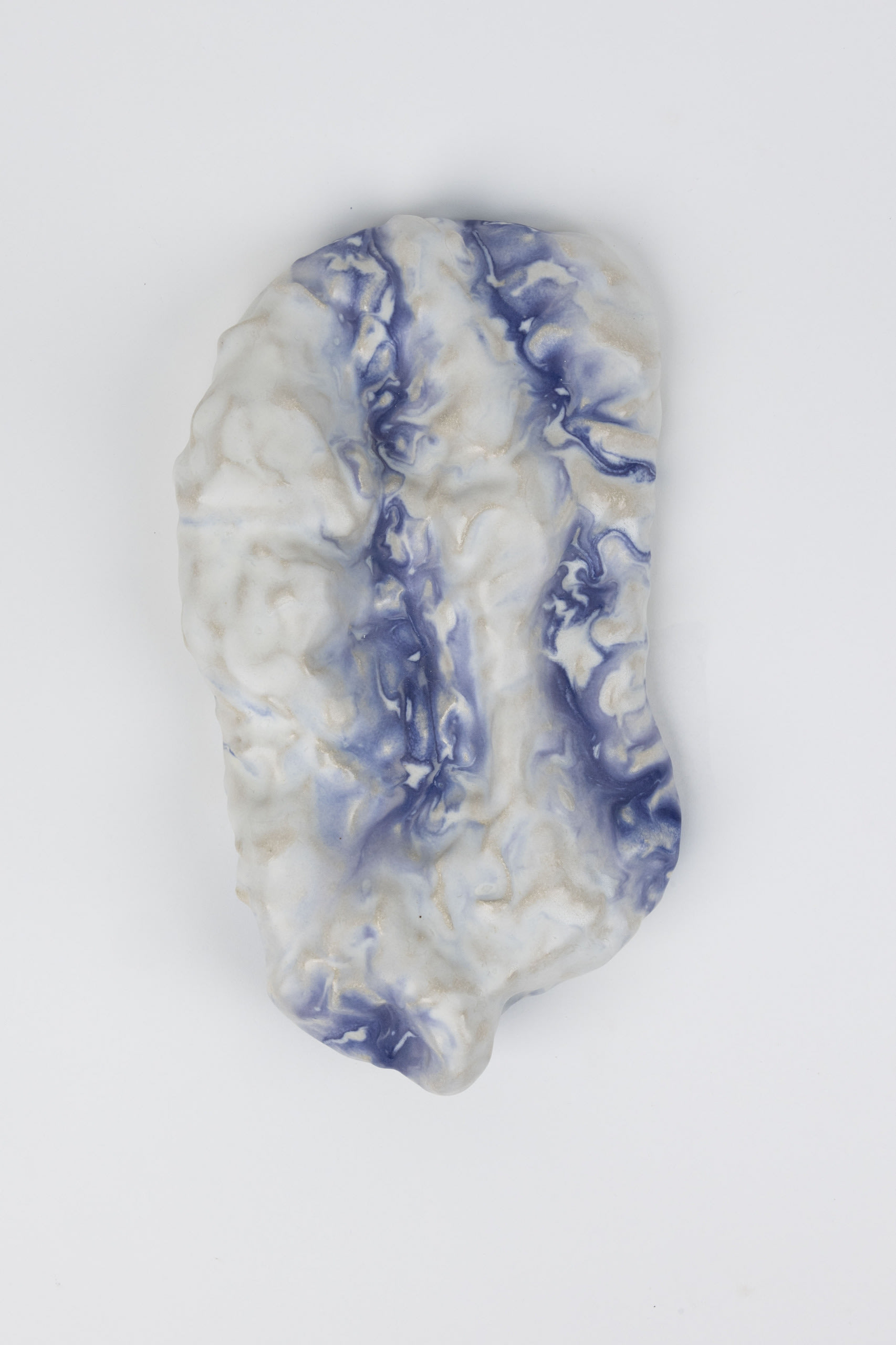 Tactile ceramic piece in blue and white. Colours flowing together  