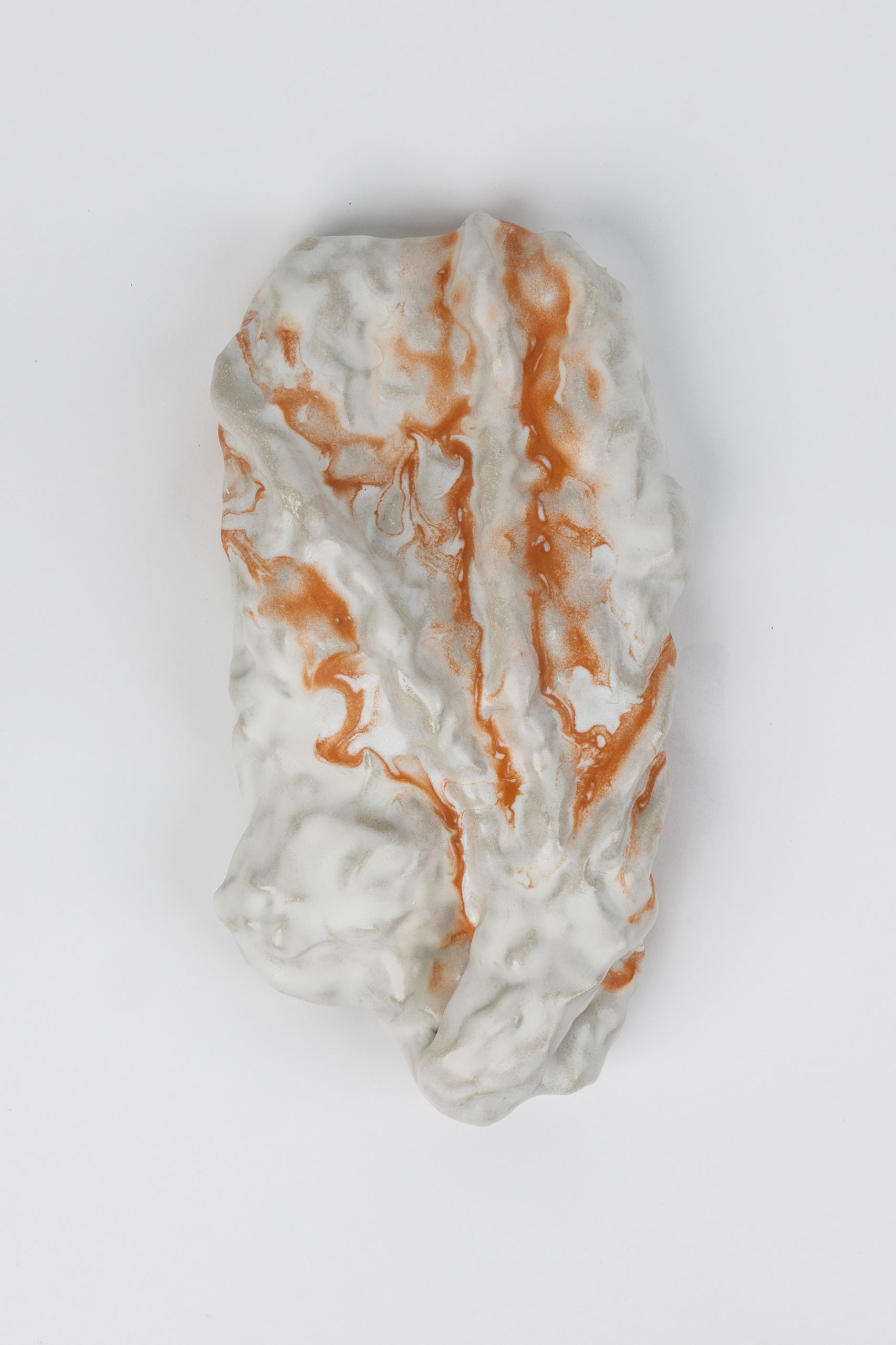 Tactile ceramic piece in orange and white.  Colours flowing together 