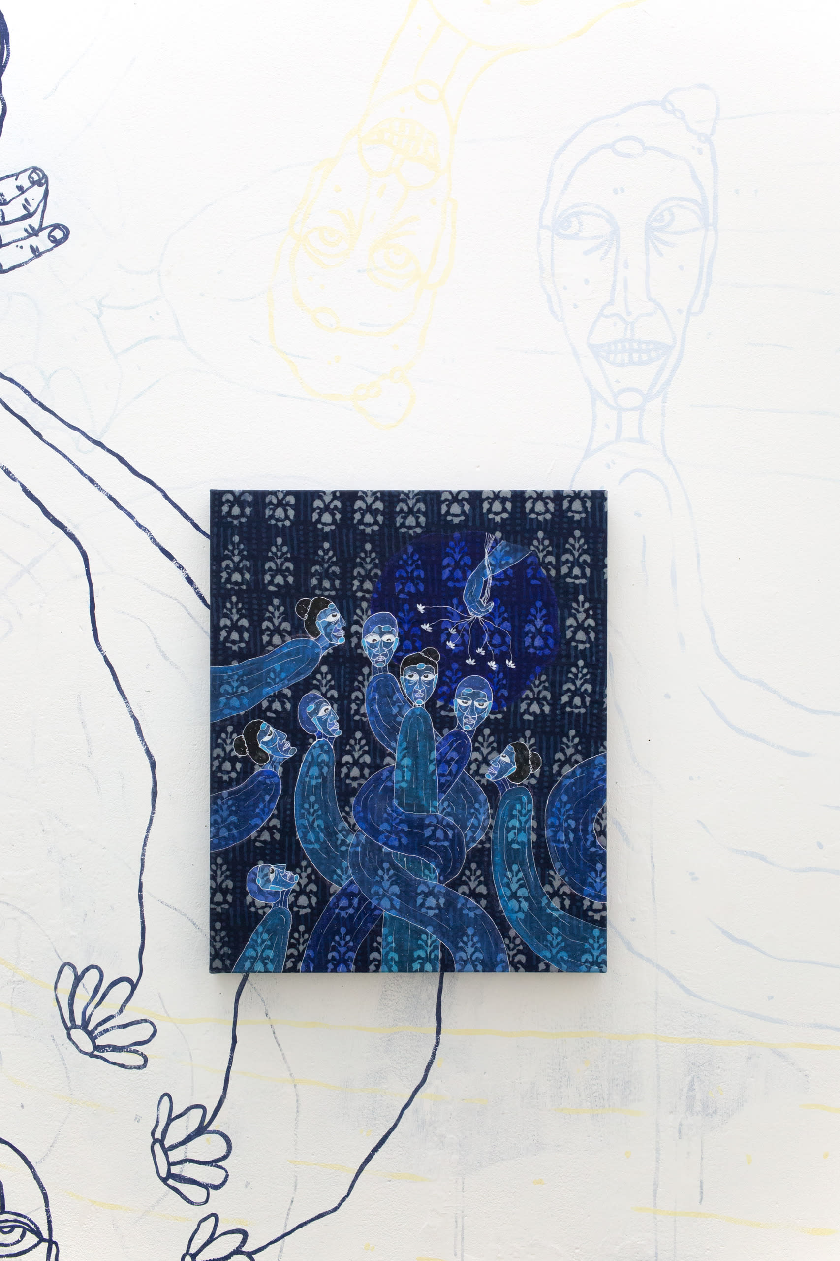 detail install shot of painting on fabric, dismembered figures intertwining and moving towards hand holding flowers