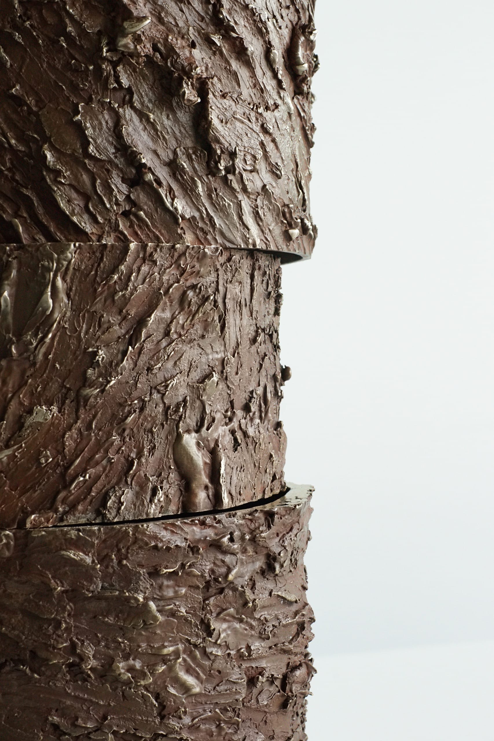 Close up of the painted texture of this large bronze sculpture. The intense rugged texture moving towards each other. 