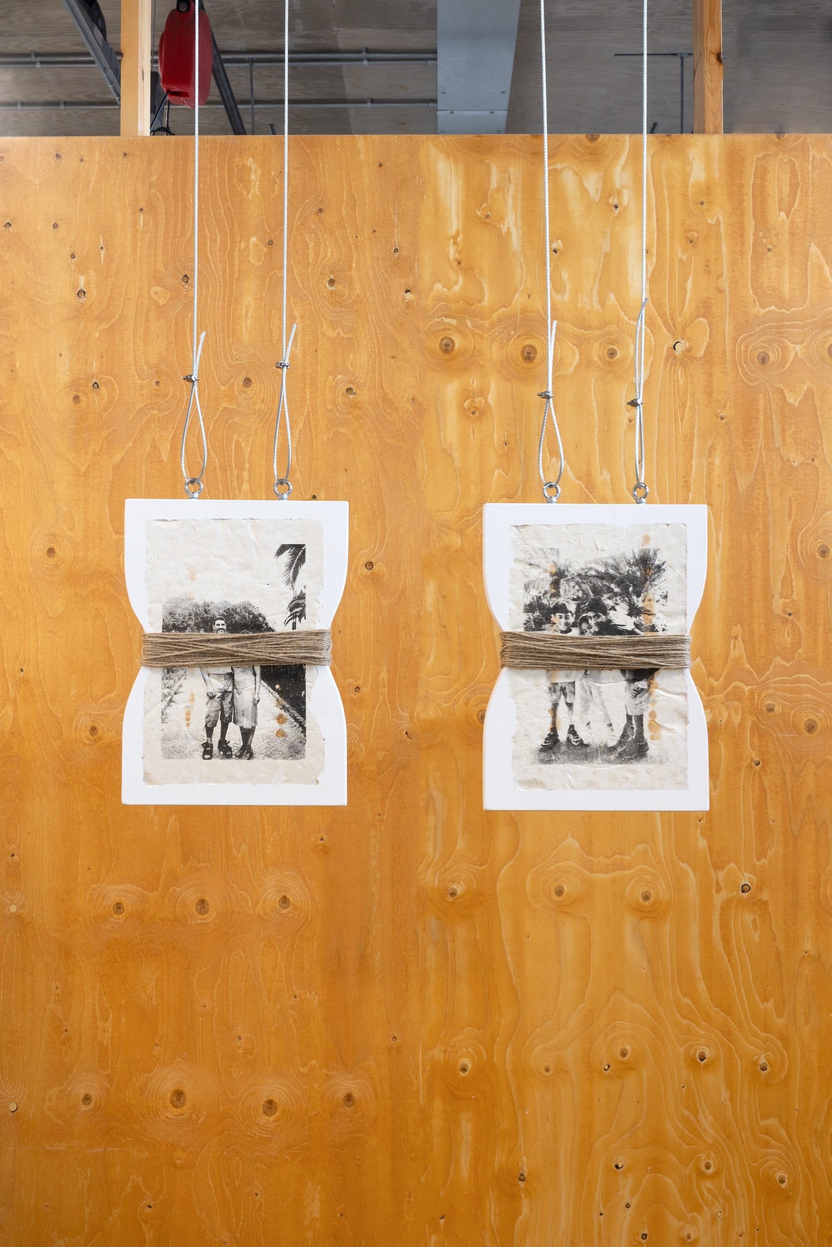 Screen prints of my family embedded into jesmonite. The two jesmonite tiles wrapped with hemp rope, hng from steel wire. 