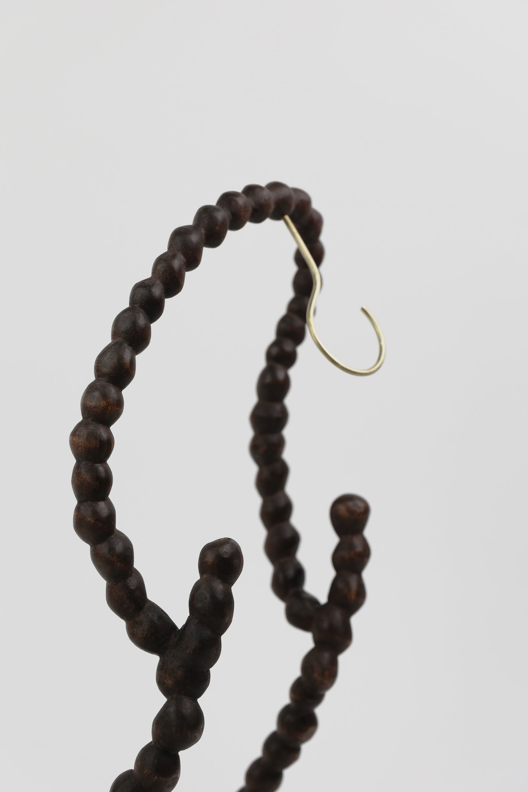 two strings of hand-carved wooden pearls with two brass hooks on each side 