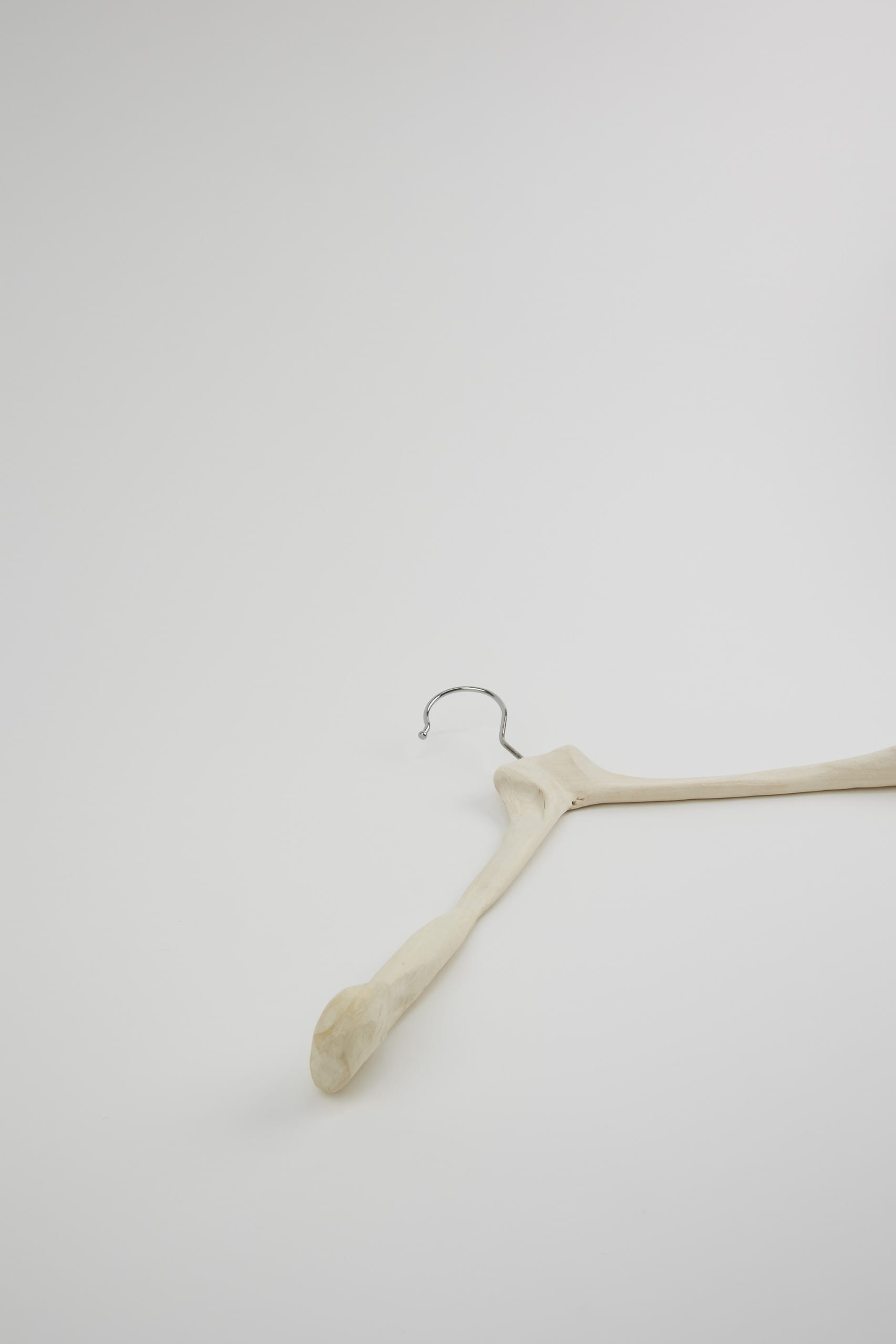 a carved bone-like hanger