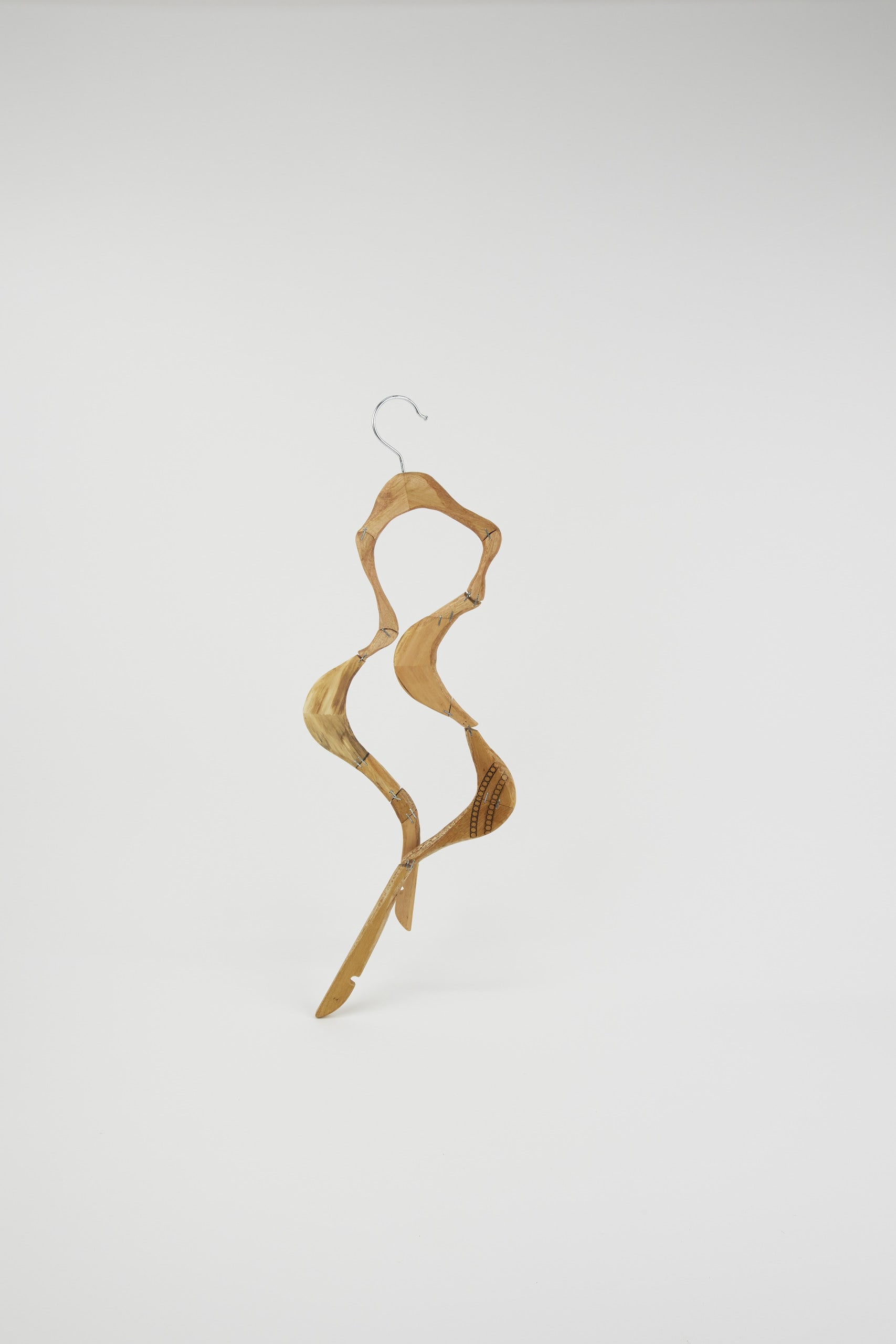 a dancing coat hanger with joints from other parts of the hangers 