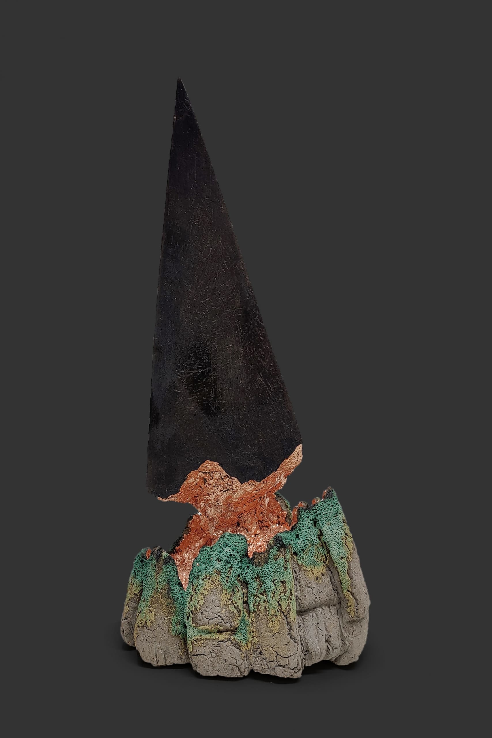 An image of ceramic sculpture by Chloe Lennon with metal copper leaf and volcanic glazes representing nature and industry. 