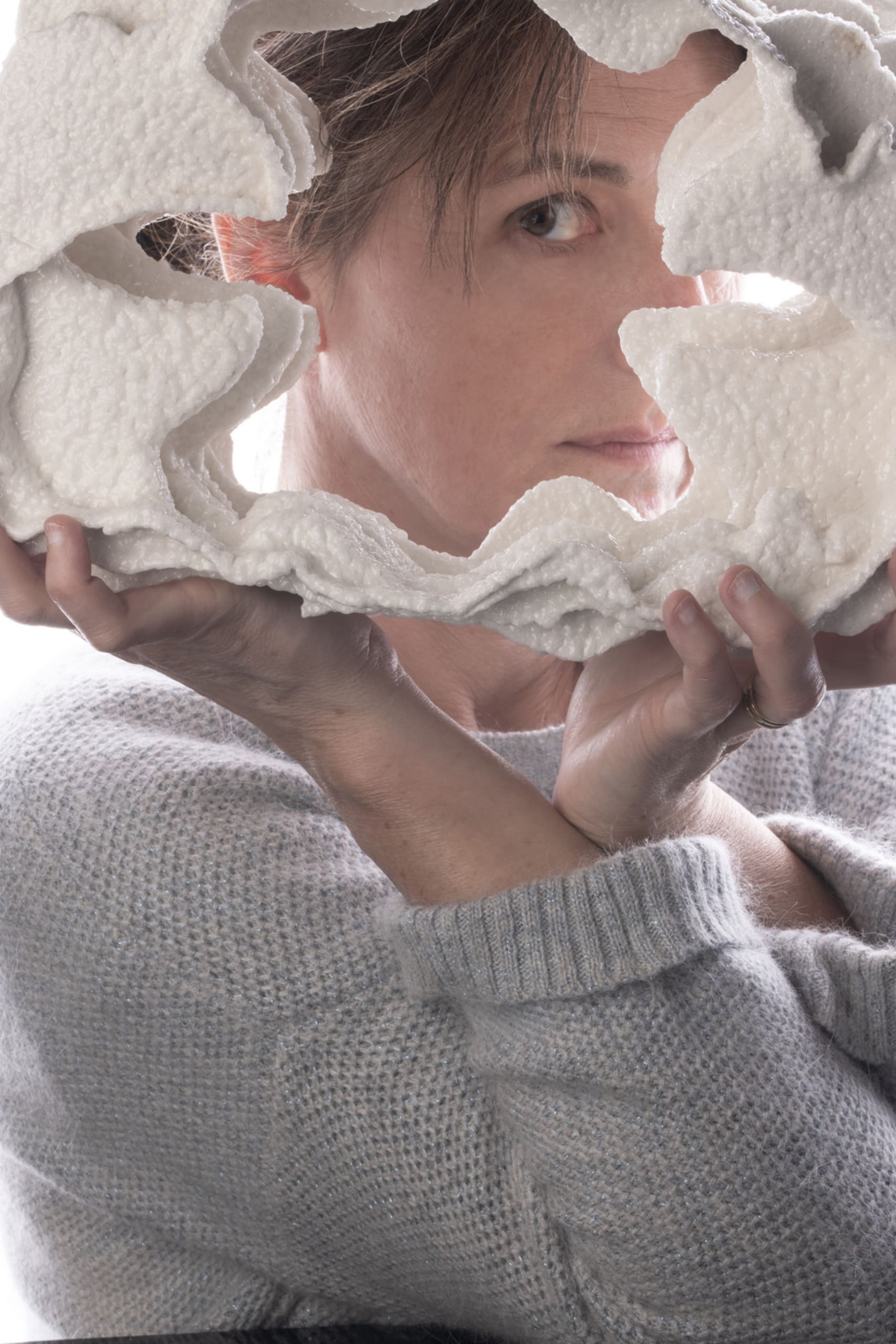 close up of white porcelain with textured glaze, like floating crystals salt and myself behind