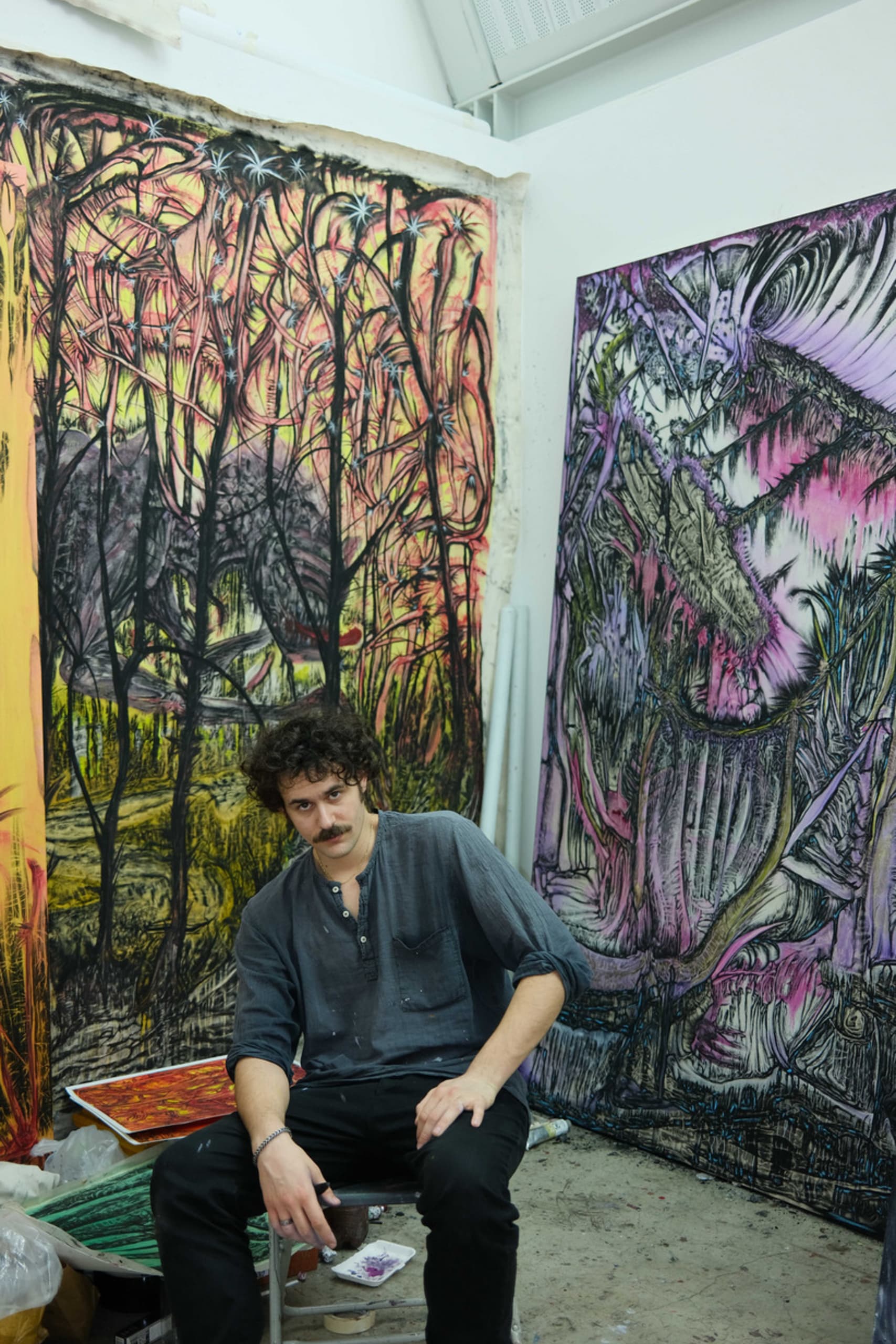 the artist standing infrond of his works