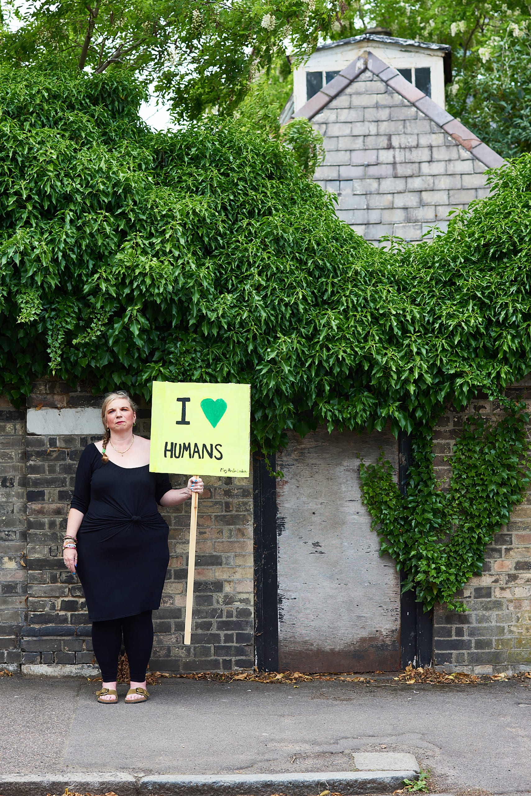 Mary Amelia London stands holding a sign saying: 'I heart humans'