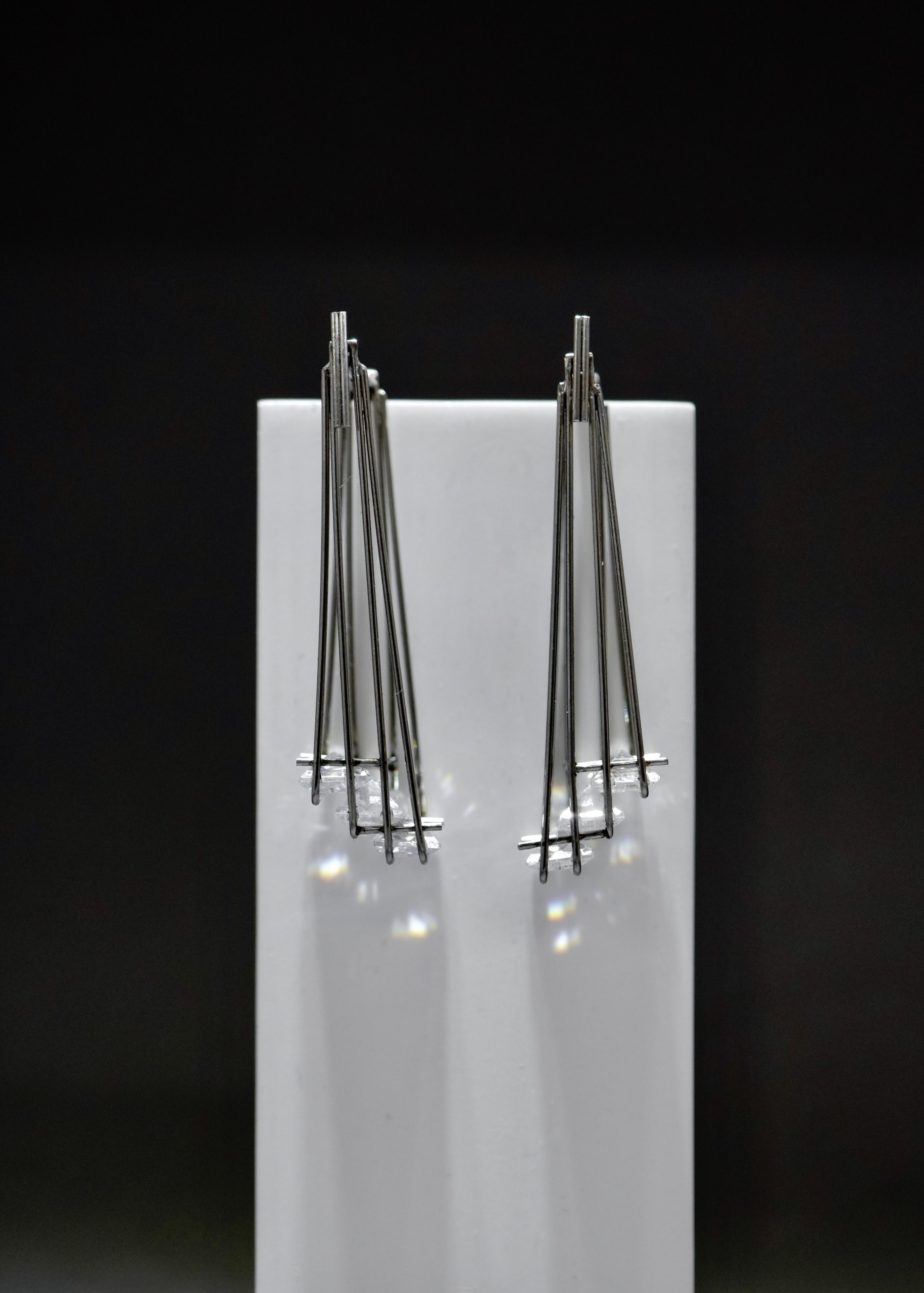 earrings inspired by chandelier, three stones set on each side.