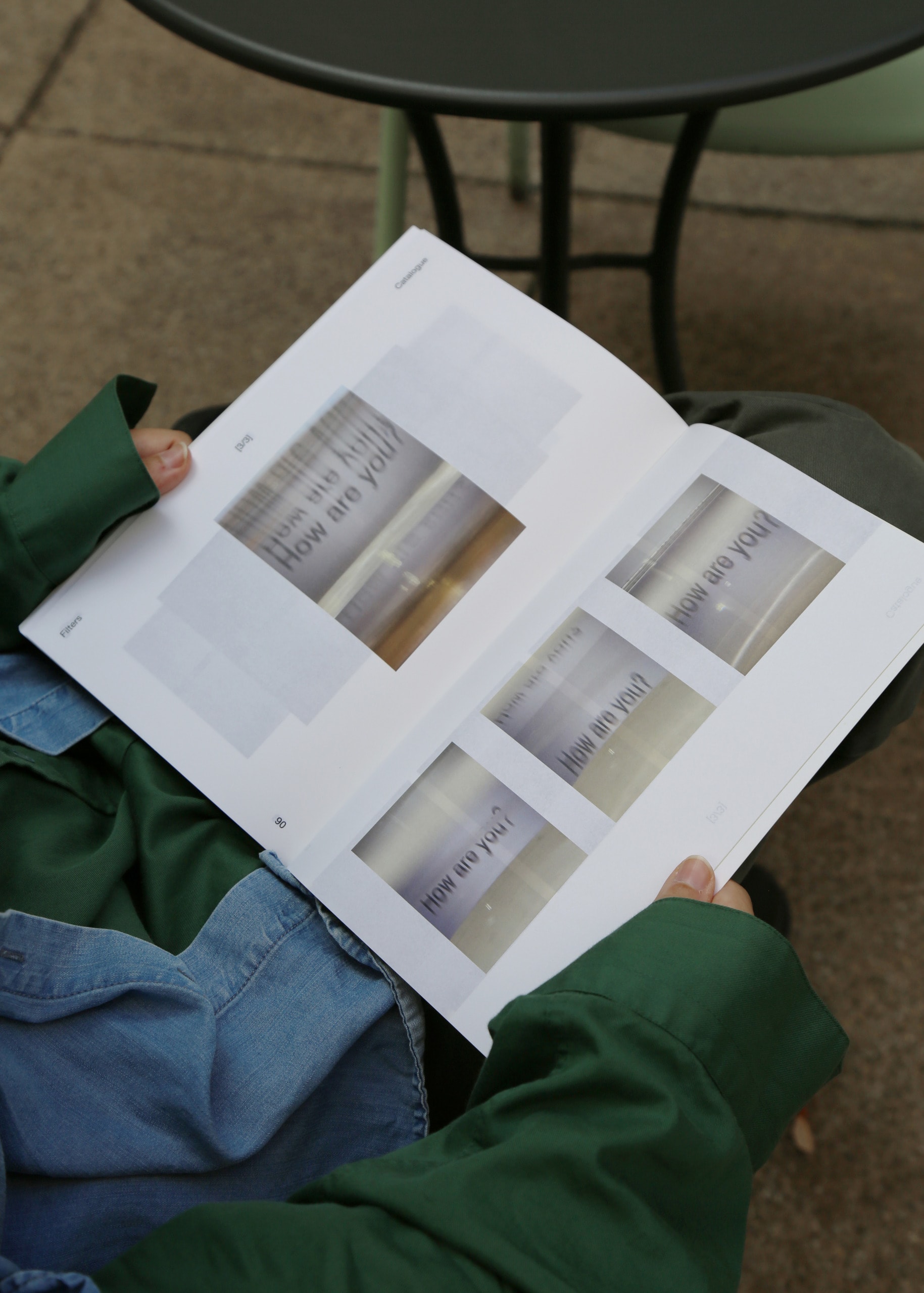 Reader holding book with distorted pictures saying 'How are you?'