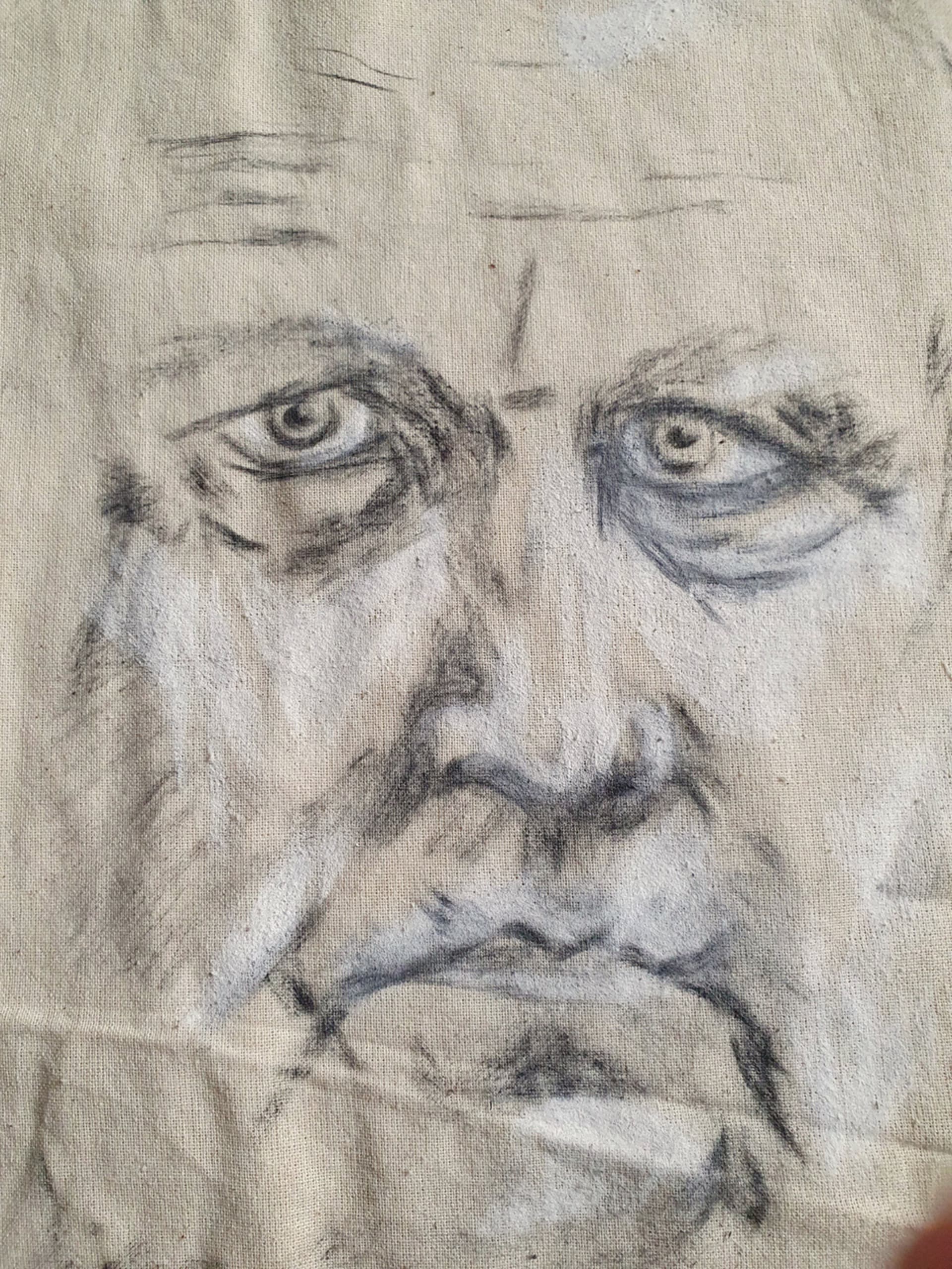 Charcoal self-portrait on a canvas tote bag. 