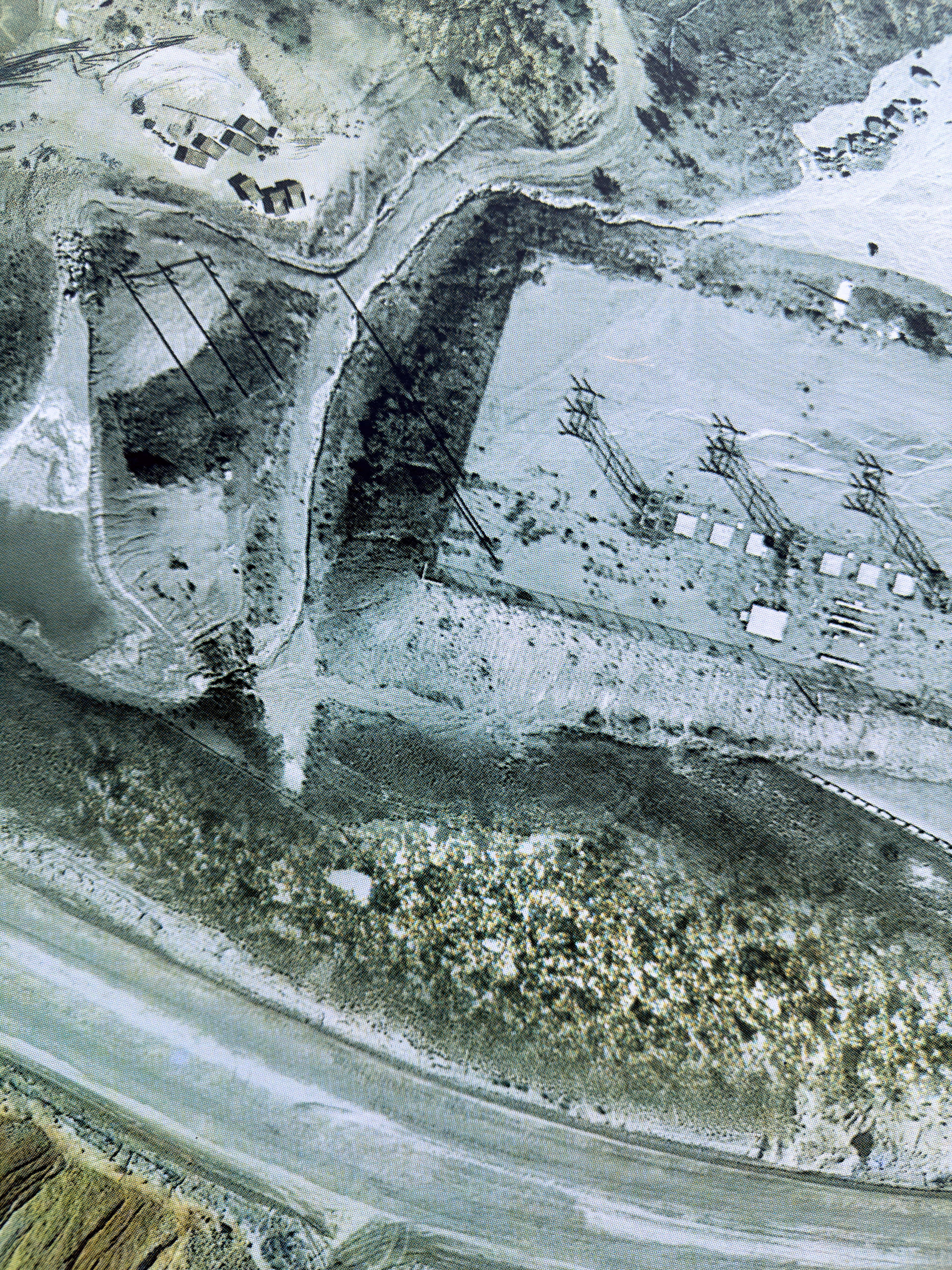 Detail of screen print on paper depicting microscopic and satellite imagery of landscape at an open pit mine.