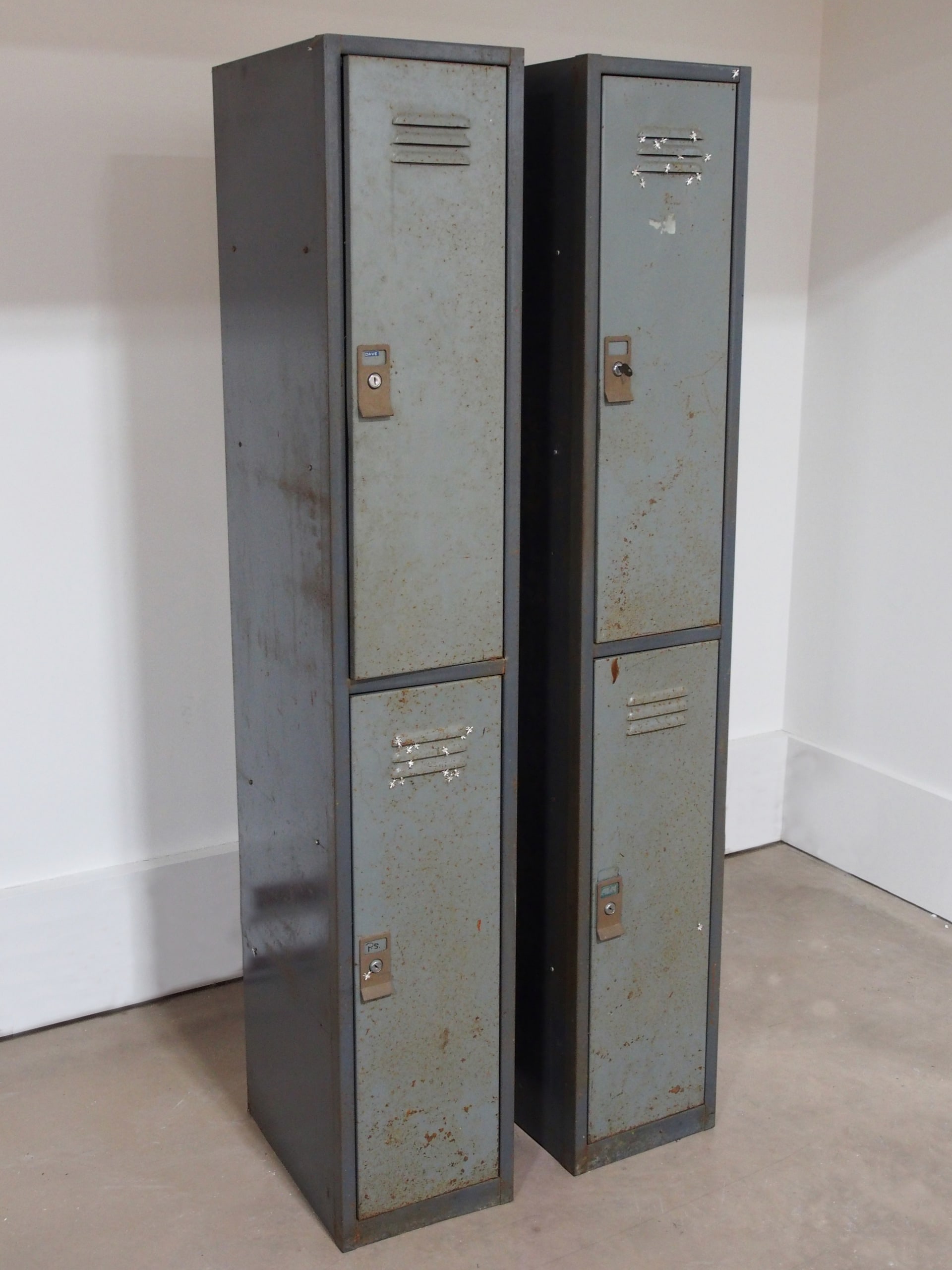 two metal lockers with silver ants swarming around the vents on the doors