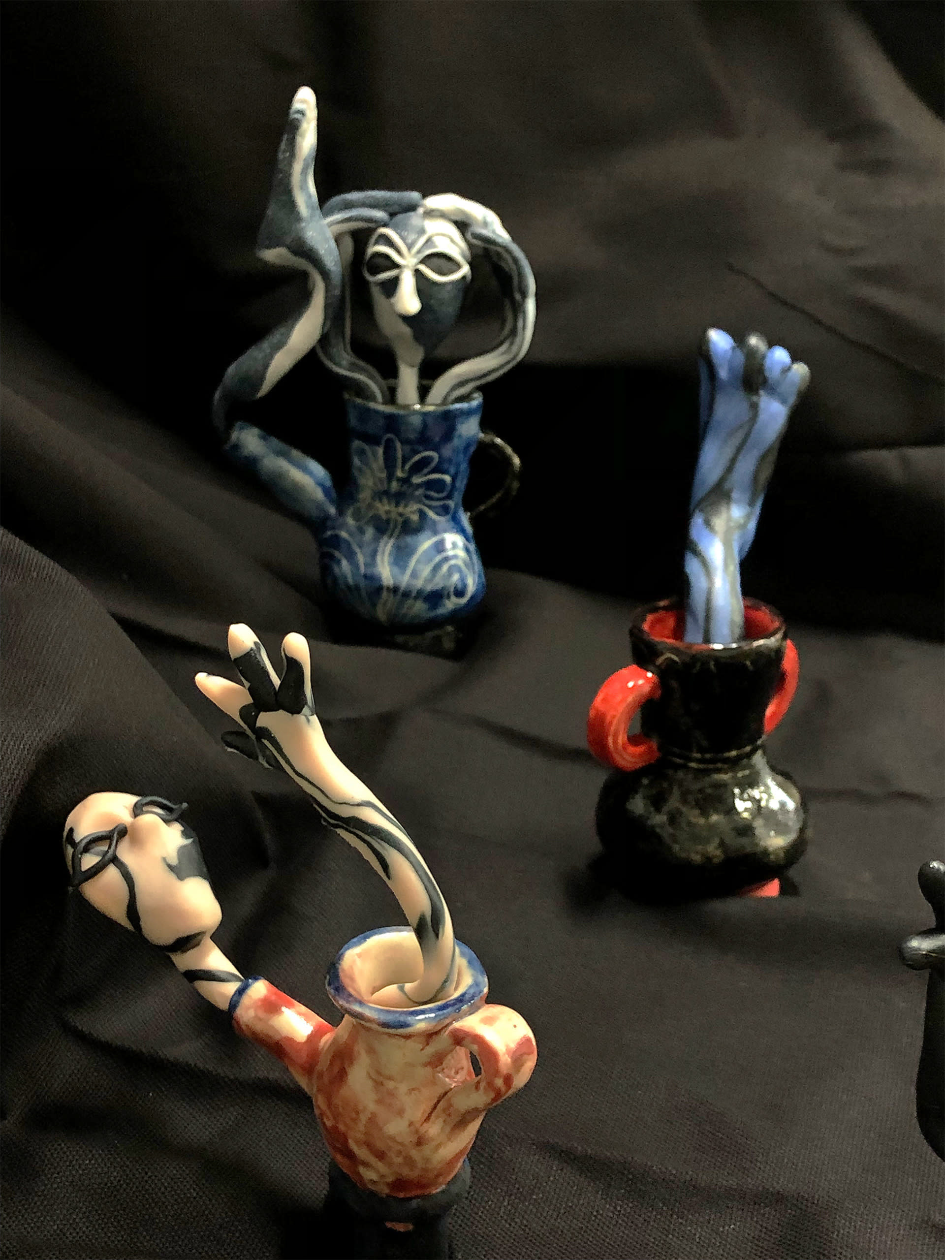 Three ceramics vessels from which two entities and a foot stick out