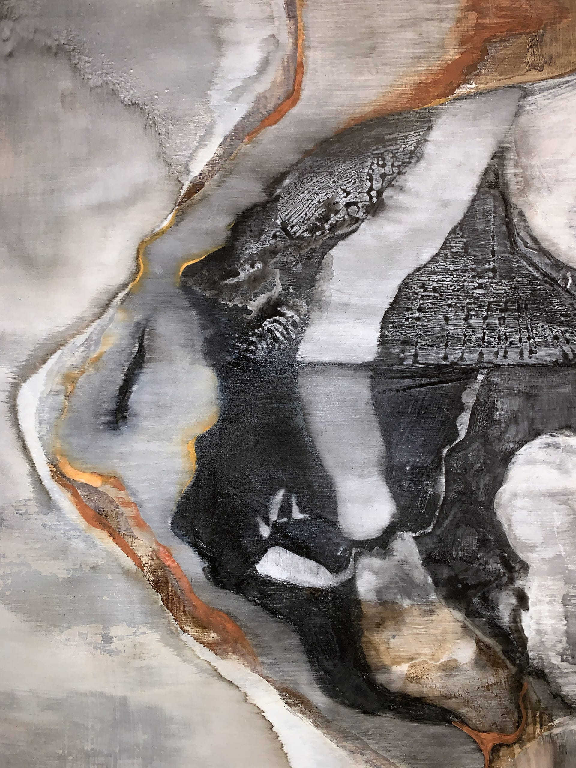 close up of 'continental drift'; face/mountain in blacks orange yellows white