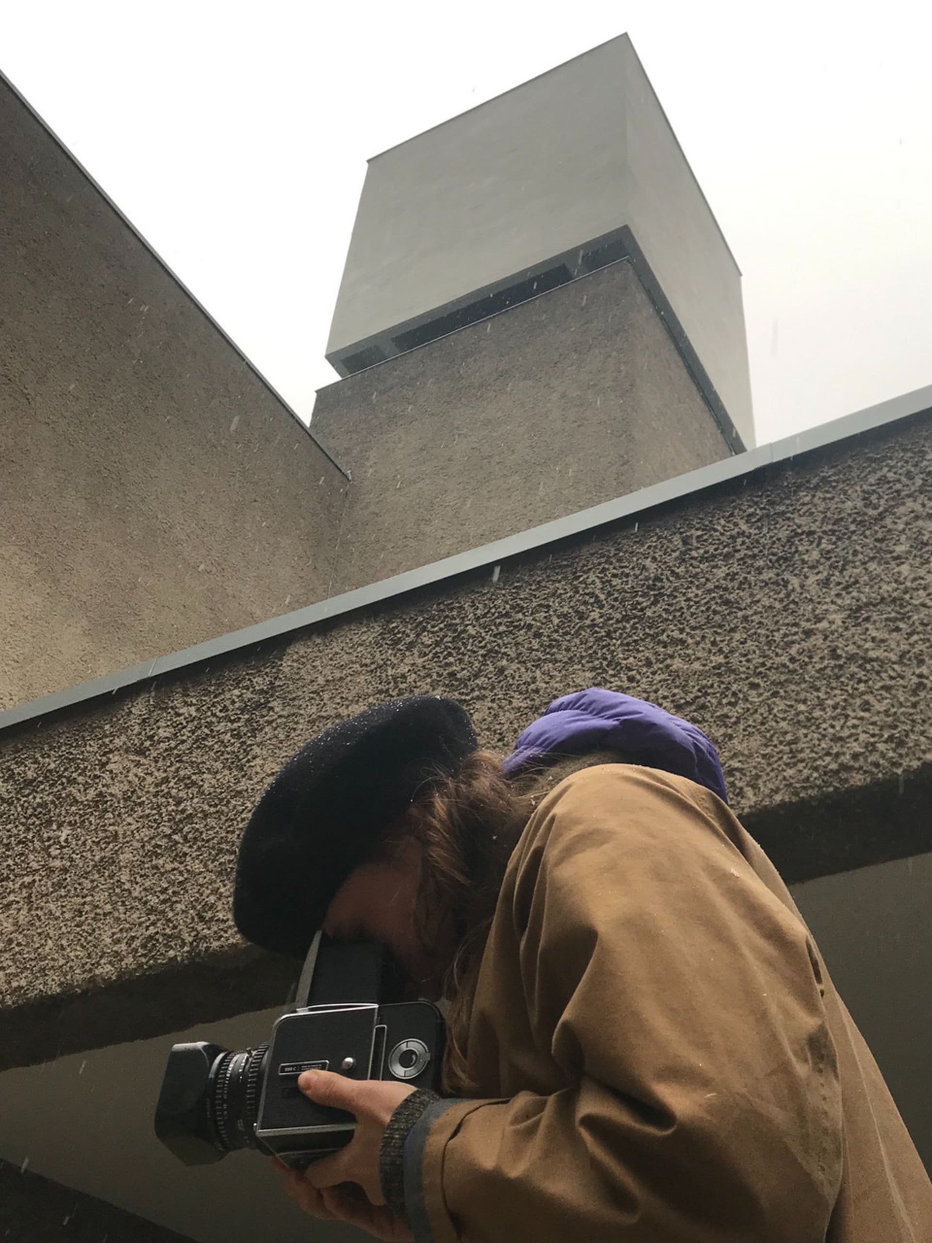 A person taking an image on the analogue camera