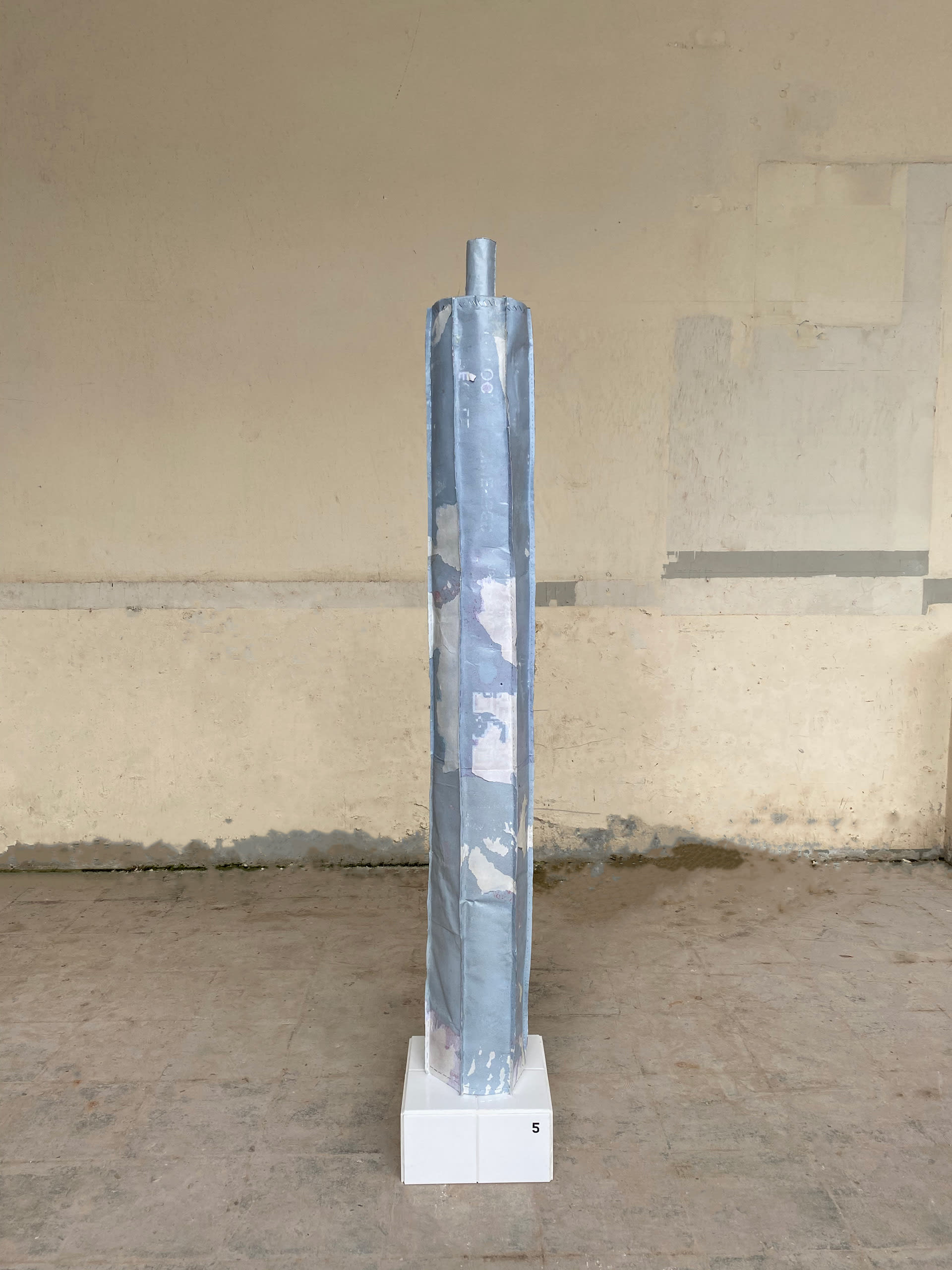 A column made out of street posters. 