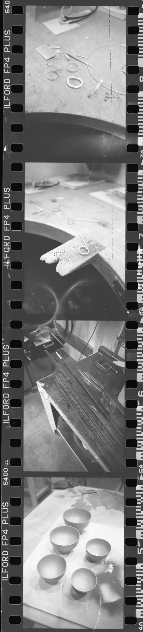 Scanned image of black and white negatives of work in progress shots, (silver ring making, metal working, pottery)