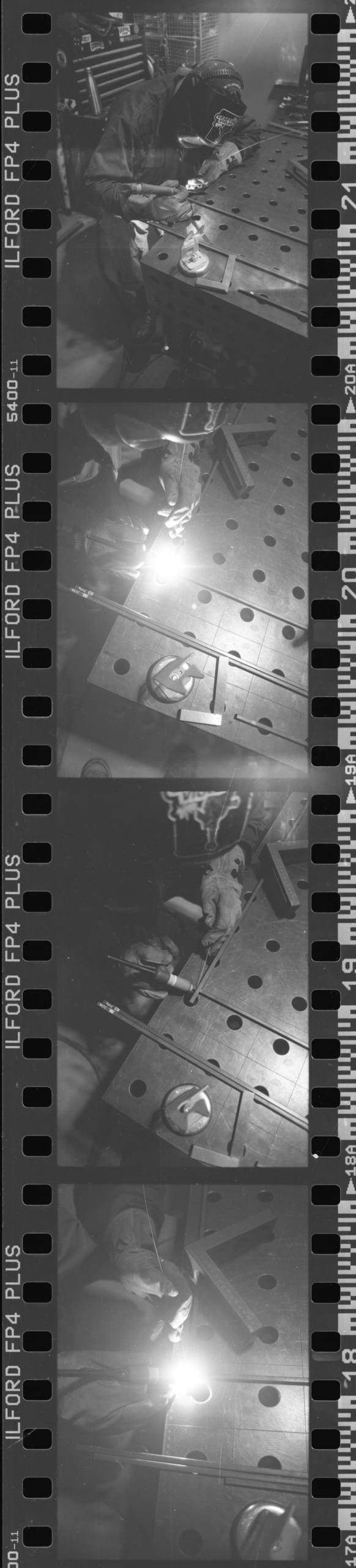 Scanned image of black and white negatives of work in progress shots, (silver ring making, metal working, pottery)