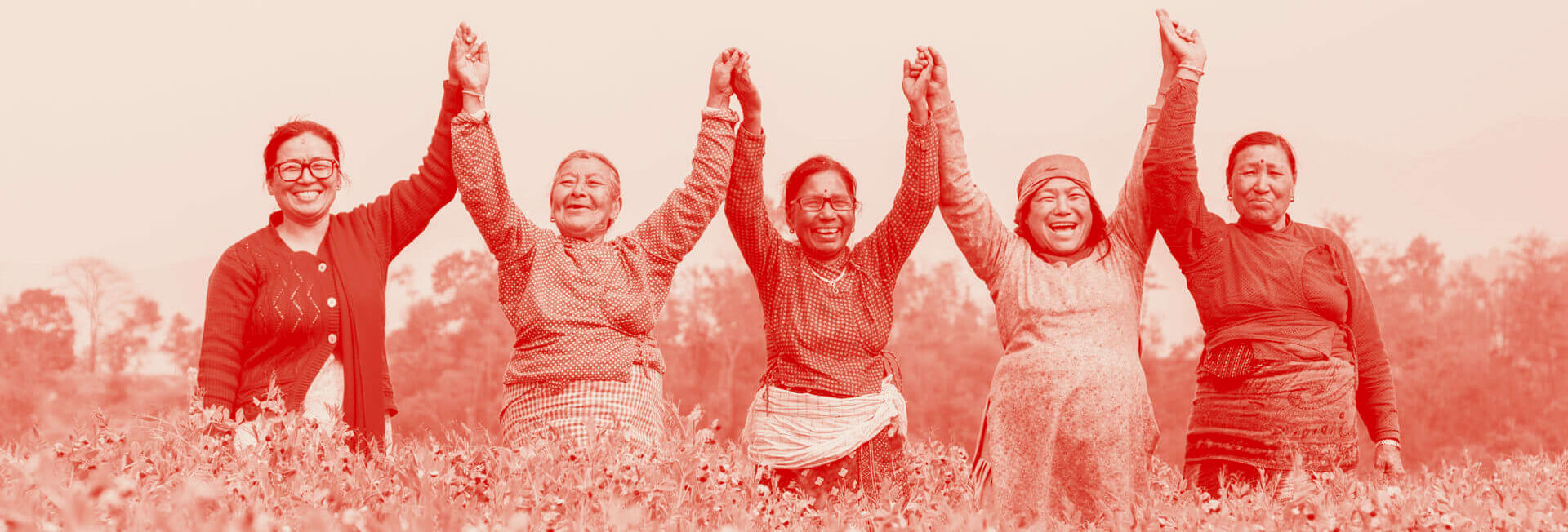 nepali women holding hands smiling 