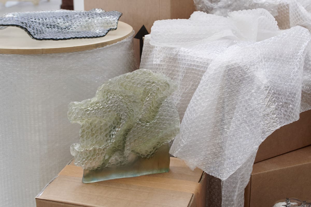 a mix of glass bubble wrap and real bubble wrap on cardboard boxes