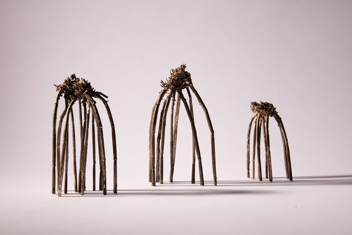 Three upturned wheat stems cast in bronze