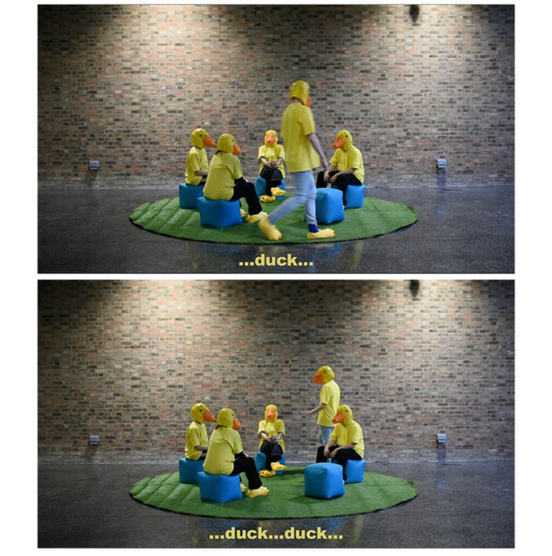 Performance, 4 people dressed as ducks sat on beanbags.