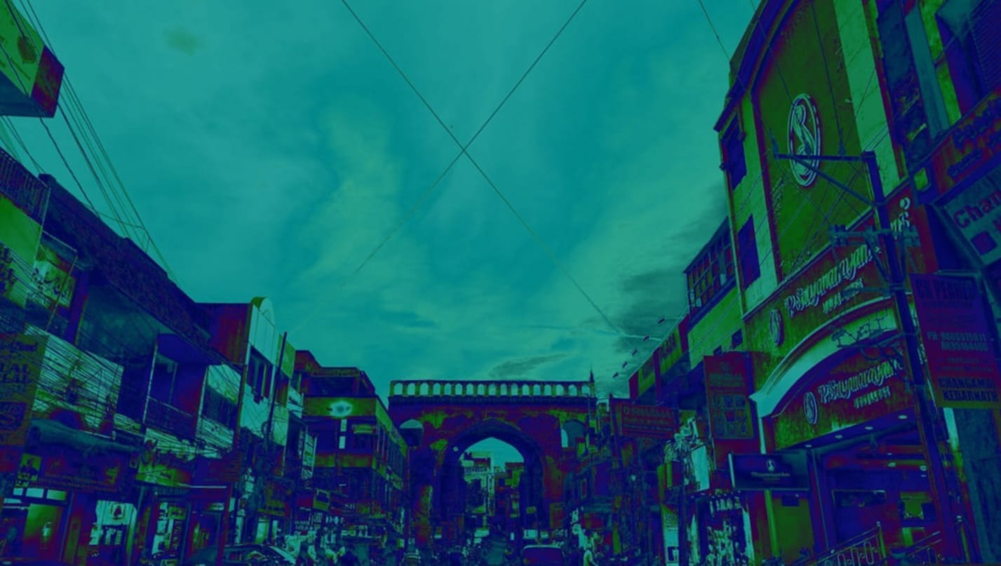 Blue-green filtered image of a busy street in an Indian city