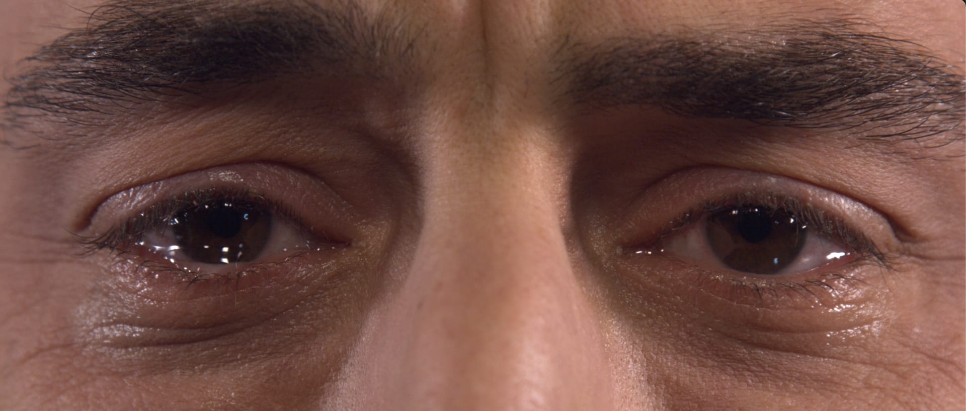 Close up shot of the protagonist's eyes welling up.