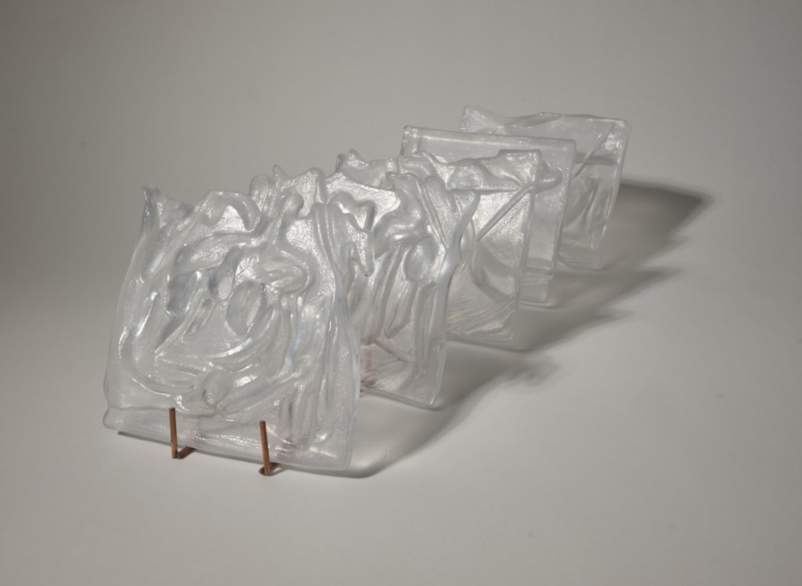 5 cast transparent glass pieces layered one after another with each piece being 14 x 14 x 2.5 cm