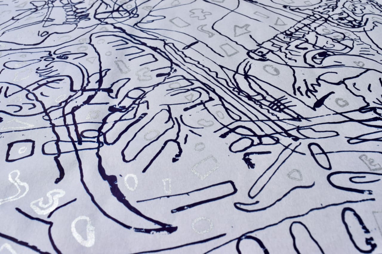 Close-up photograph of screen print navy and silver ink on white Japanese paper