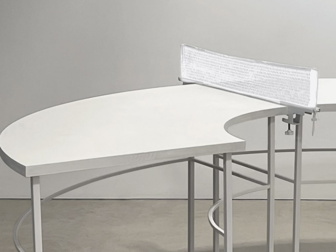 A ping pong table is built in semi-circle and painted in white.