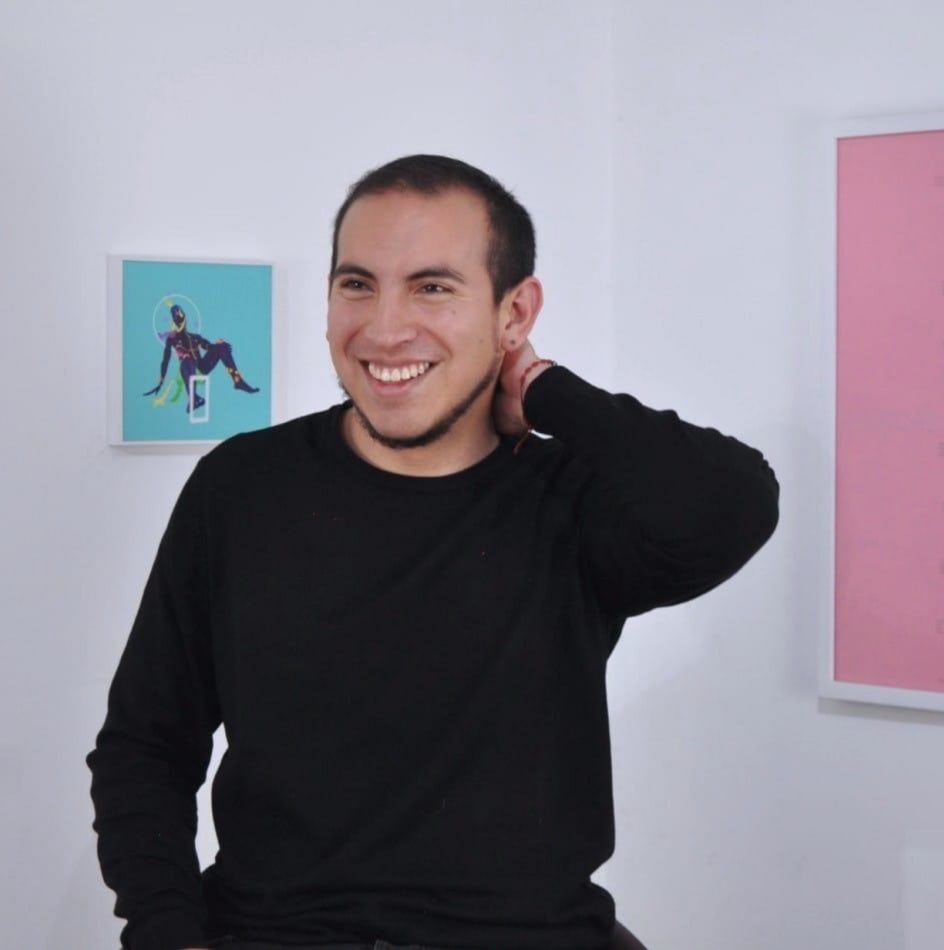 Luis López wearing a black sweater at his exhibition space.