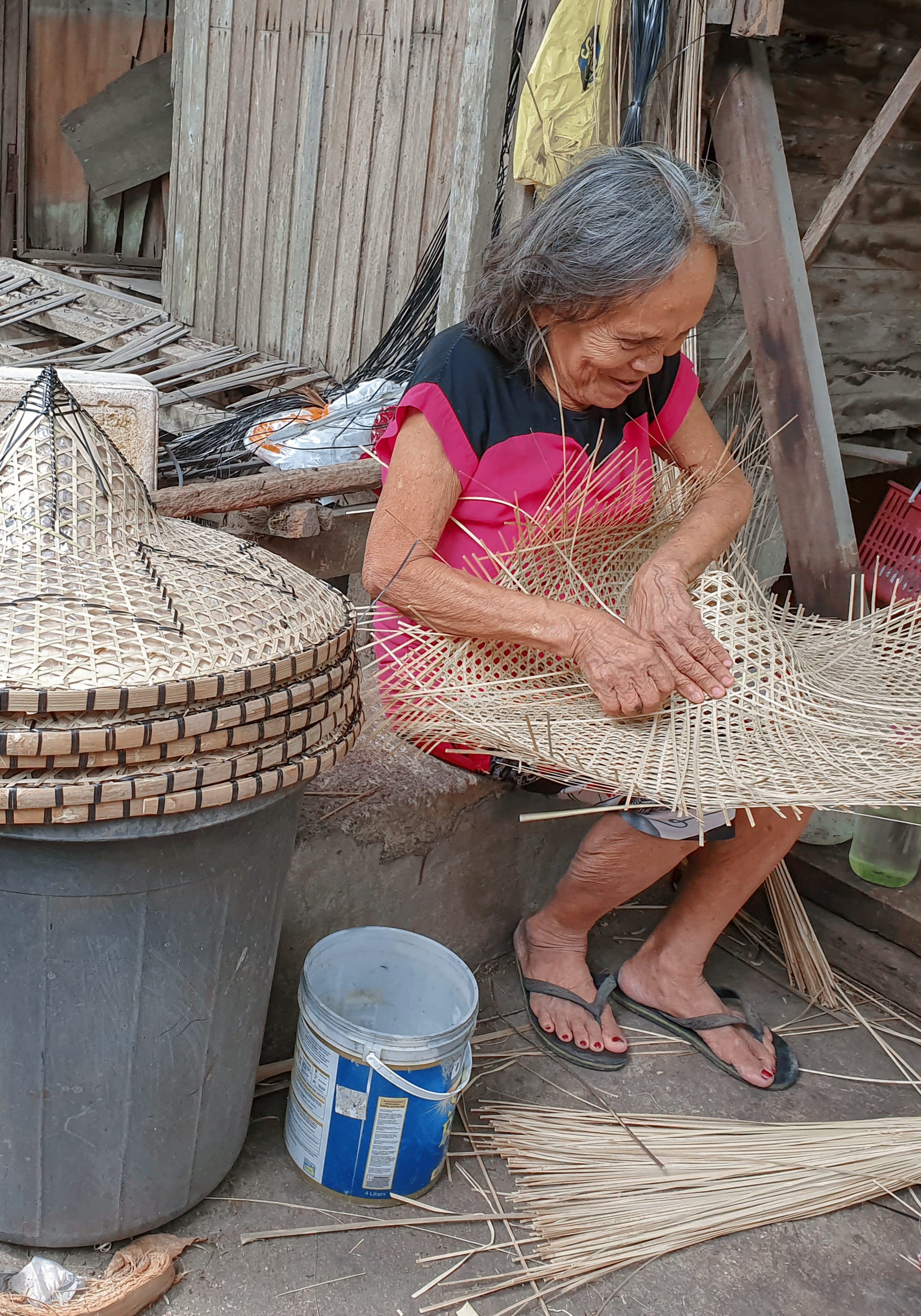 Weaving the strips into a rain hat