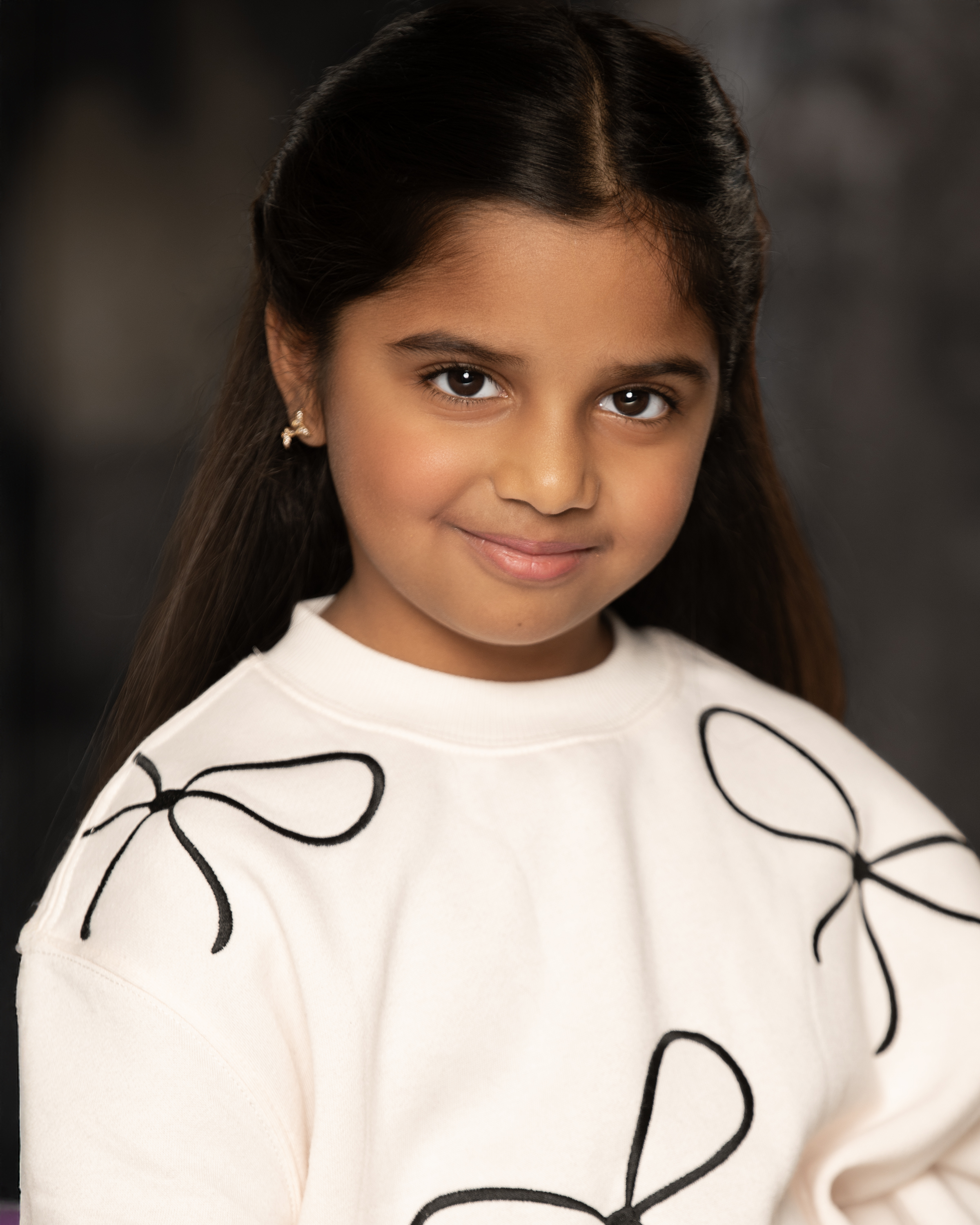 Natasha’s studio portrait in a white patterned top