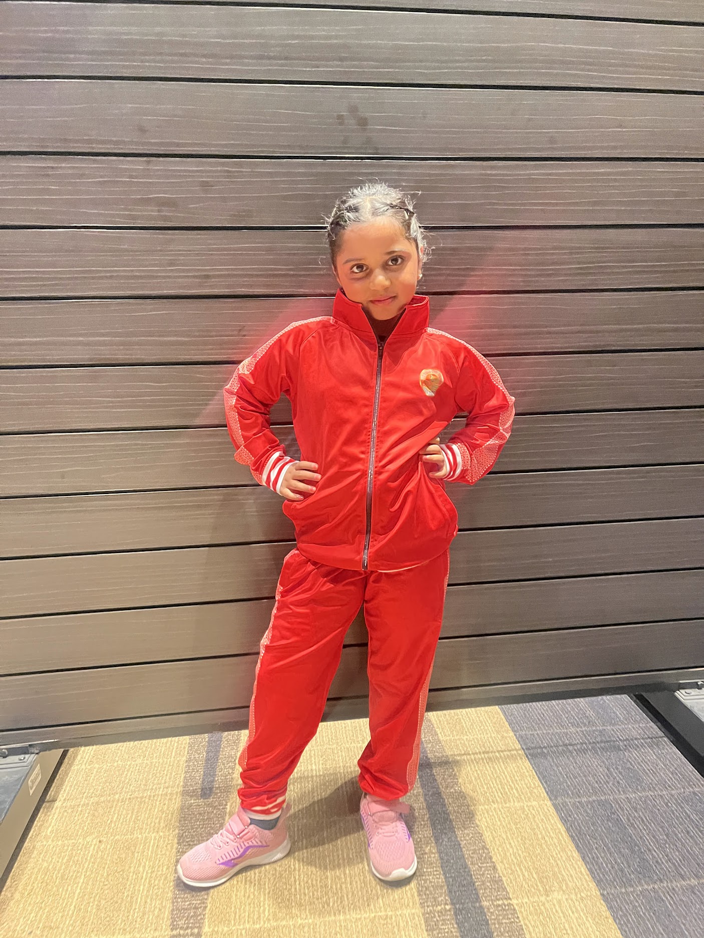 Natasha in a red tracksuit and pink shoes