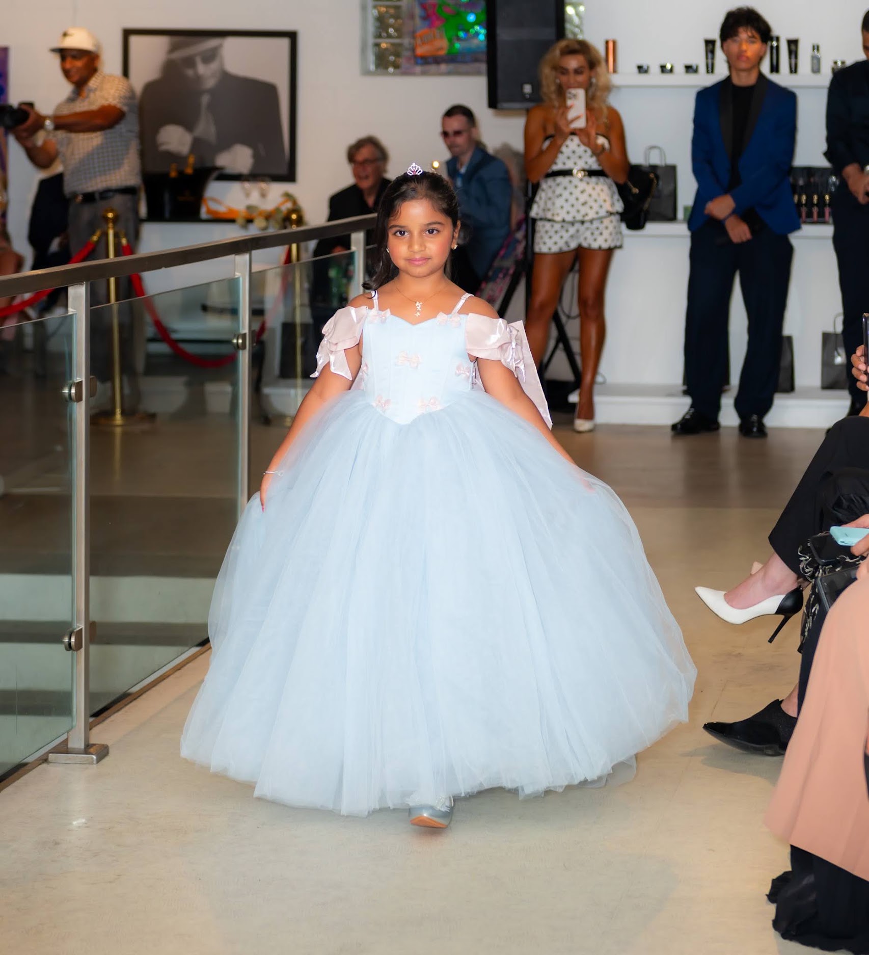 Natasha walking the runway in a pale blue gown