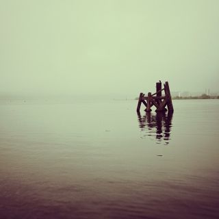 Wood structure stands in the water of Cardiff bay