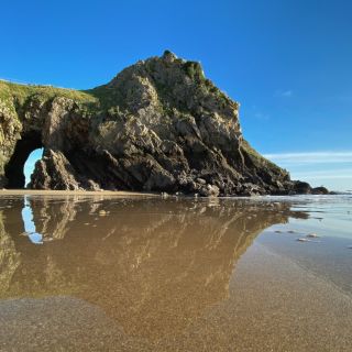 Caldey island reflected in the sand on a beach