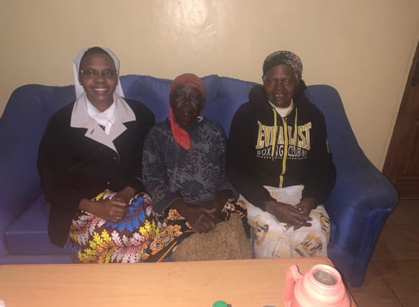 Beneficiary seated on couch