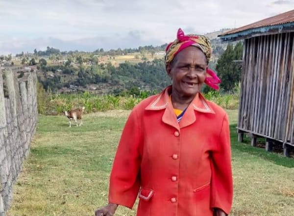 Woman with shovel at well site