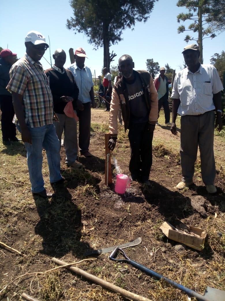 Men at well digging site