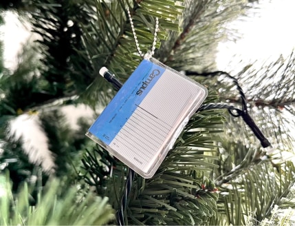 A tiny version of the Kokuyo Campus ruled notebook as a tree ornament.