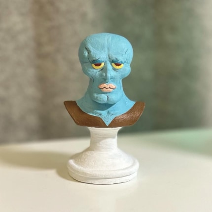 A photo of a 3D printed and painted bust of handsome Squidward from SpongeBob SquarePants.