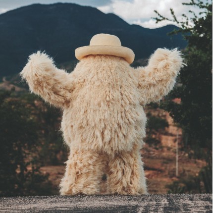 Photo of beige fuzzy monster in a beige hat. Fernando Laposse photo featured in the book Broken by Katie Treggiden