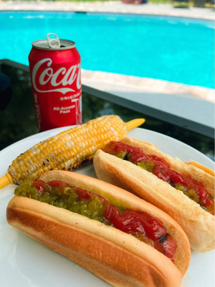 Hot dogs, corn on the cob, and Coca-Cola