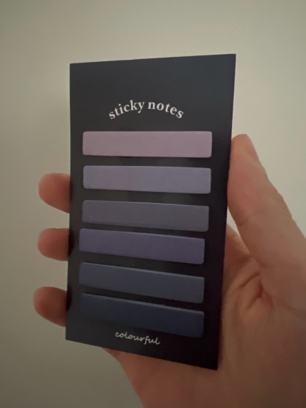 Photograph of a “colourful sticky notes” card, with 6 thin sticky note strips on it. They are all purple but range from light to darker purple in colour