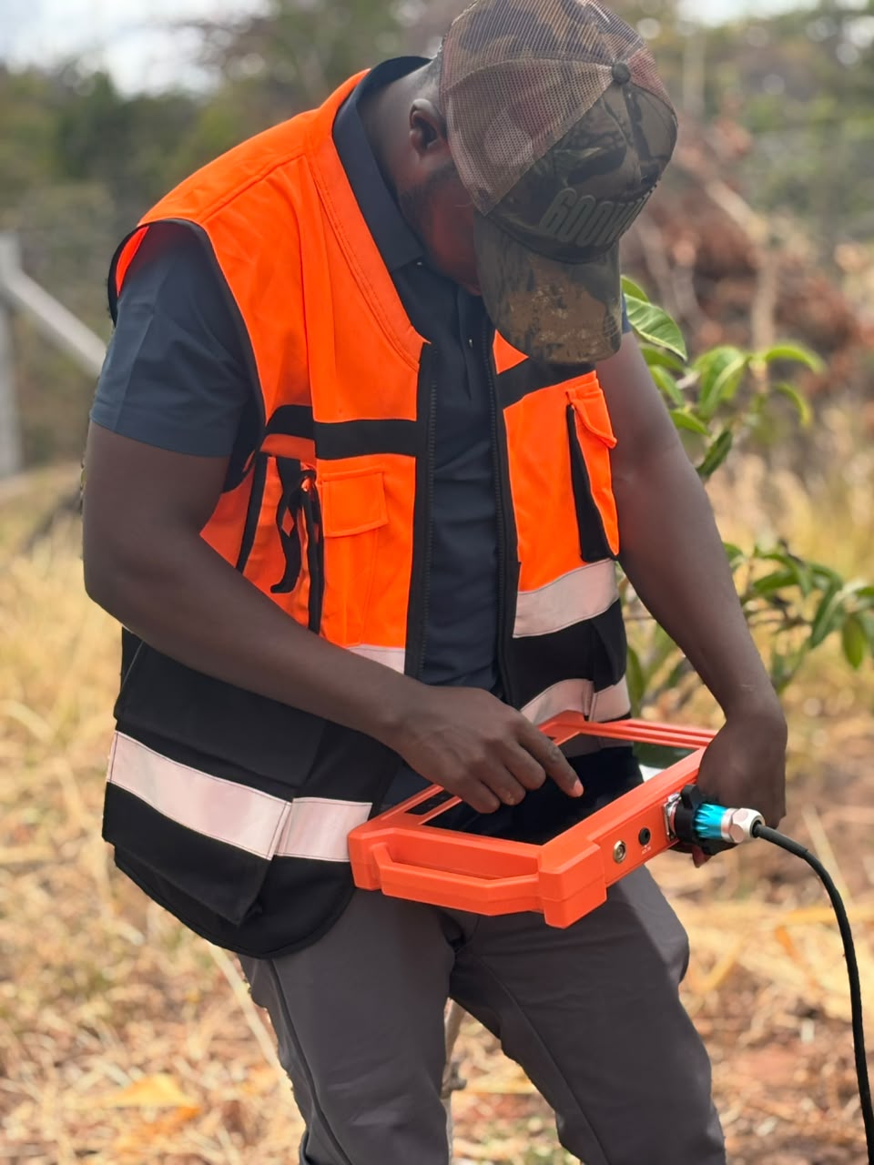 Maji Source engineer recording borehole site data on a tablet