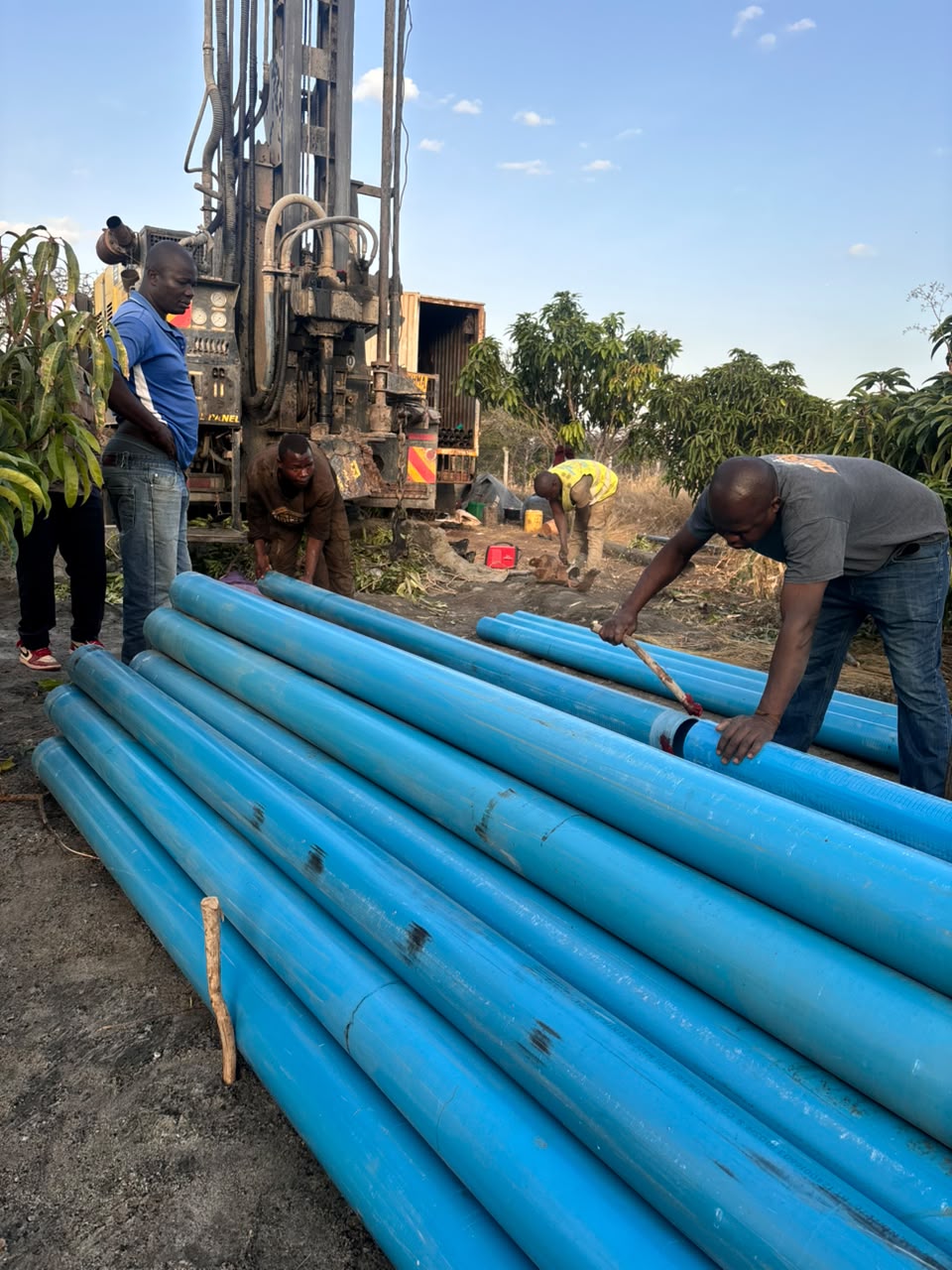 Maji Source engineer with a tablet on a borehole site